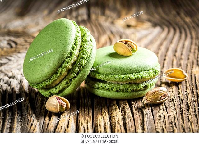 Green pistachio macaroons on a wooden table