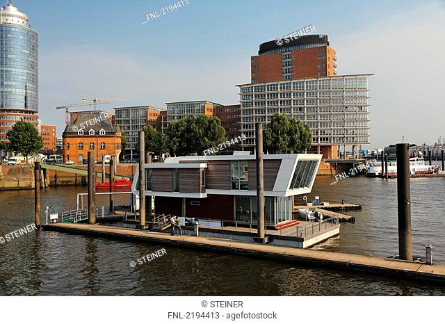 Floatinghome in river, HafenCity, Hanseatic Trade Center, Kehrwiederspitze, Elbe River, Speicherstadt, Hamburg, Germany