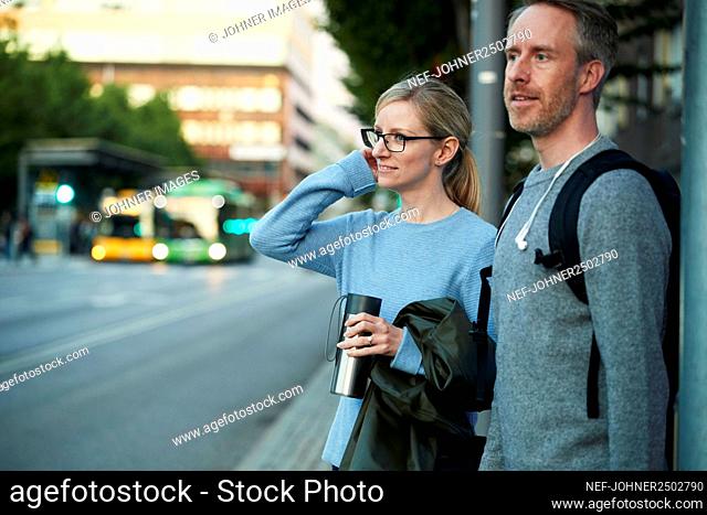 Man and woman standing at roadside