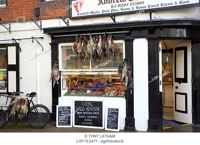 England, Shropshire, Ludlow, Game hanging outside a local butchers in Ludlow