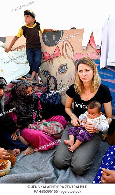 EXCLUSIVE - UNICEF ambassador Eva Padberg holds four-month-old Zaim in her arms during a visit to the Debaga refugee camp between Mosul and Erbil, Iraq