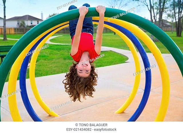 children kid girl upside down on a park ring