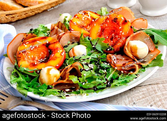 Salad with dried ham, grilled nectarine, mozzarella and arugula