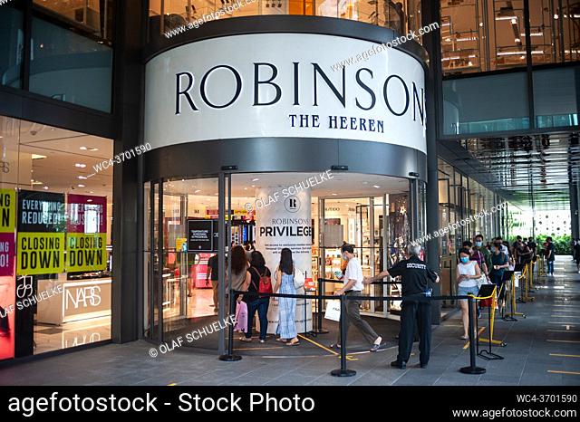 Singapore, Republic of Singapore, Asia - Shoppers queue to enter the Robinsons department store at The Heeren along Orchard Road shopping street