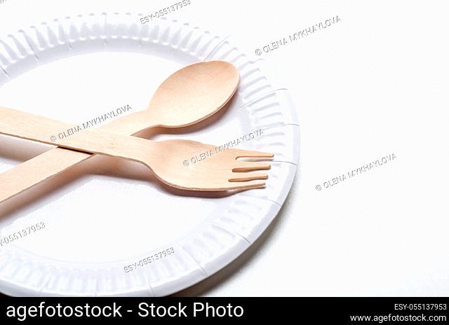 Wooden single use kitchenware and paper plate on white background