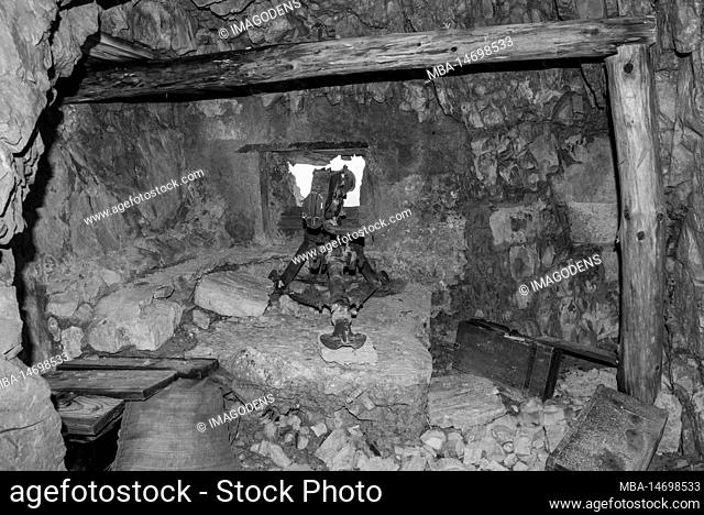 A loophole and an old machine gun in a tunnel of Mount Lagazuoi in the Dolomite Alps, built during the First World, Autonomous Pronvince of South Tirol