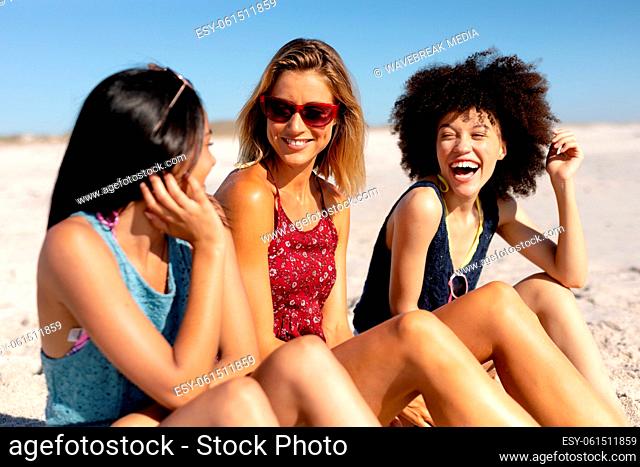 Multi-ethnic group of female sitting on the beach
