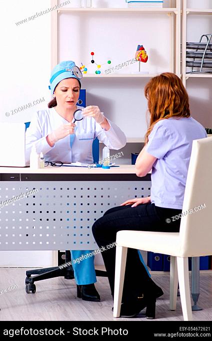 The young woman visiting female doctor otolaryngologist