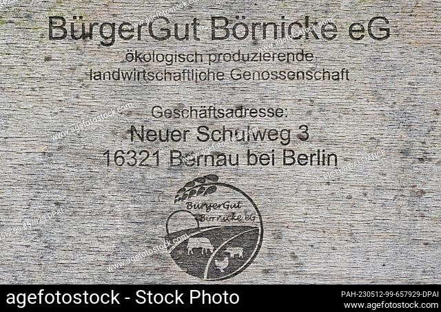 26 April 2023, Brandenburg, Börnicke: The logo of Bürgergut Börnicke eG can be seen on a wooden door. Cooperative members finance the ecological cultivation of...