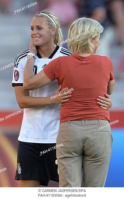 Coach Silvia Neid (r) embcraces Lena Goeßling after the UEFA Women's EURO 2013 quarter final soccer match between Germany and Italy at the Växjö Arena in Vaxjo