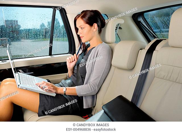 Executive businesswoman work laptop car backseat
