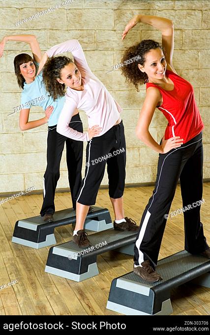 A group of young women exercising in the fitness club