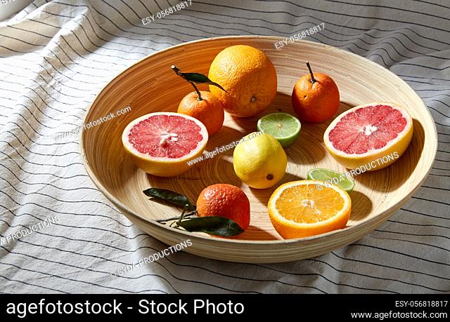 close up of citrus fruits on wooden plate
