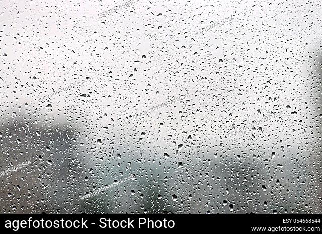 Water drops standing on the window glass after the rain. Abstract background