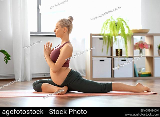 pregnant woman meditating at home