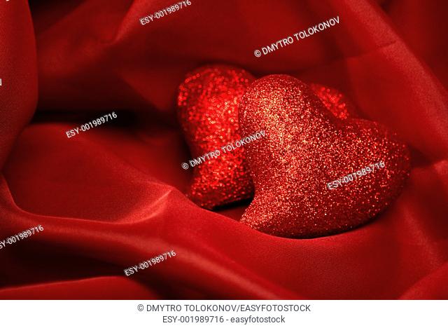 abstract Valentine's backgrounds over red textile with tho hearts