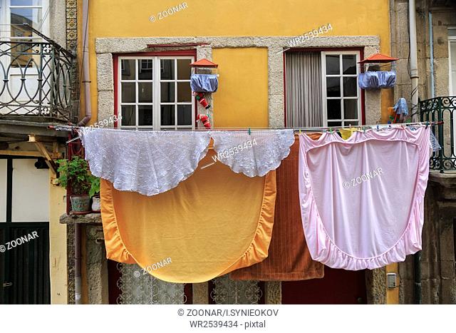 Drying linen hanging outside of house