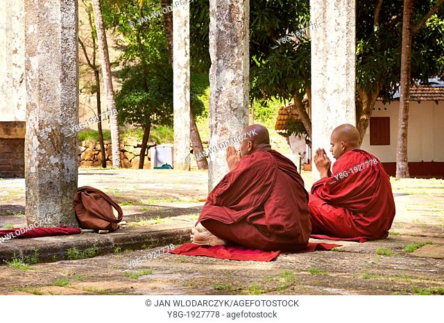 Sri Lanka - Mihintale Temple, Ambasthale Dagoba, monks sitting in front of the temple, UNESCO World Heritage Site, buddhist temple complex in Sri Lanka