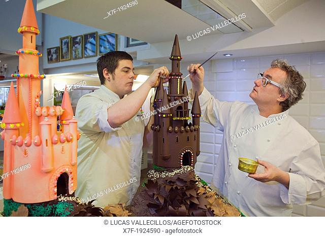 Christian Escriba and his son making a `Mona', typical chocolate cake of Pascua's monday, the godfather gives his godson, catalan tradition, Escriba  bakery