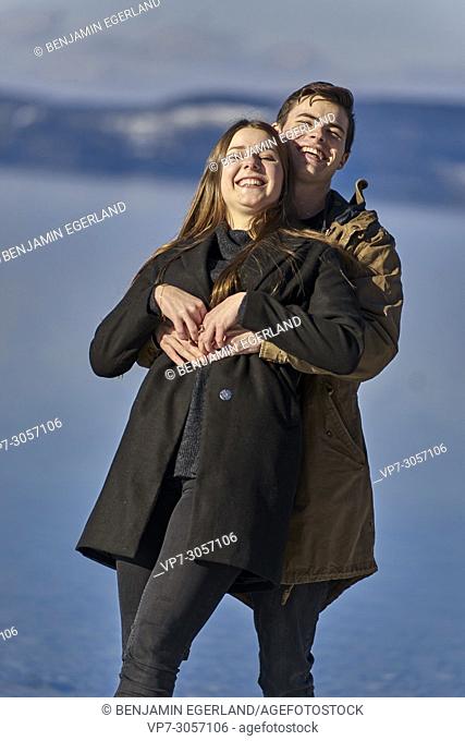 Tegernsee, Germany, playful couple in front of lake Tegernseer