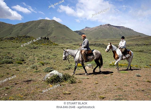 Gaucho guide and tourist on horse at Estancia Alta Vista, El Calafate, Parque Nacional Los Glaciares, UNESCO World Heritage Site, Patagonia, Argentina
