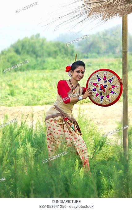 Bihu woman holding a jaapi