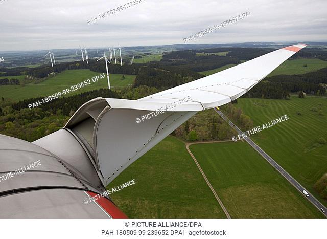 24 April 2018, Germany, Driedorf: A rotor blade of a wind turbine portruding in the sky. The machines, rotor blades and the supporting structure (tower and...