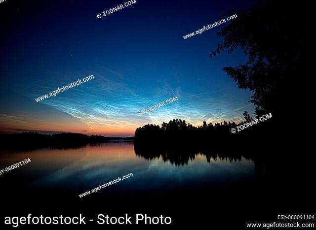 Night shining clouds over lake in Finland