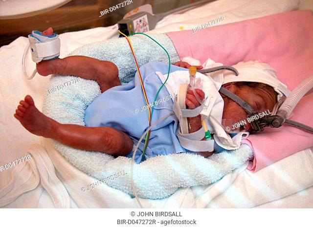 Premature baby boy in an incubator in the neonatal unit