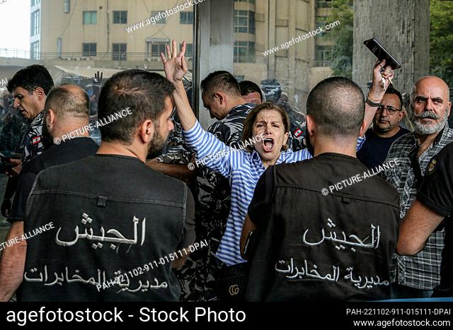 02 November 2022, Lebanon, Hazmieh: Lebanese woman shouts at policemen and members of the army intelligence securing the premises of a local bank where Lebanese...