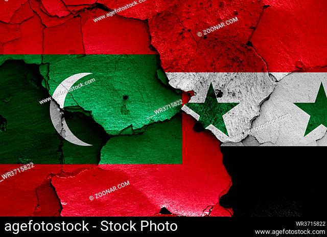 flags of Maldives and Syria painted on cracked wall