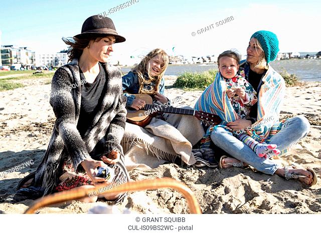 Sisters and their children enjoying beach