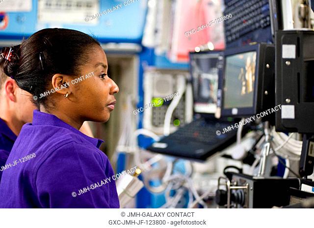 NASA astronaut Stephanie Wilson, STS-131 mission specialist, is pictured near a robotic workstation in the Destiny laboratory of the International Space Station...