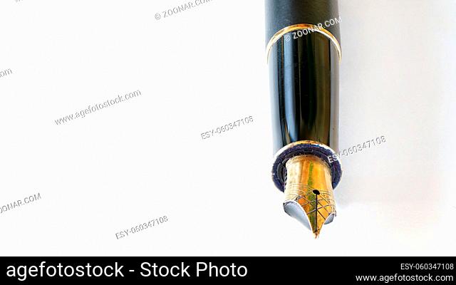 Golden coloured fountain pen nib detailed macro closeup - all imperfections and corrosion visible on metal