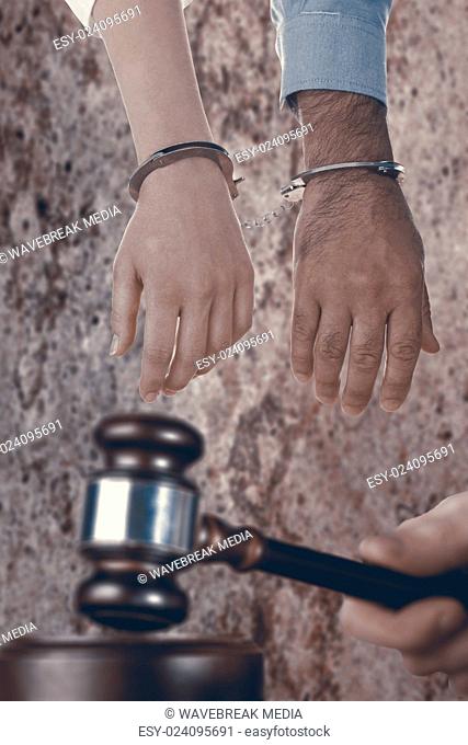 Composite image of closeup of handcuffed business people