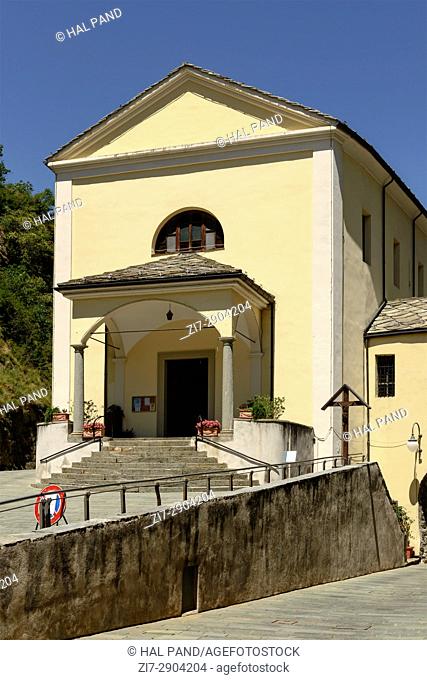 facade and protyrum of small Parish church shot on a bright summer day at Bard, Aosta valley, Italy