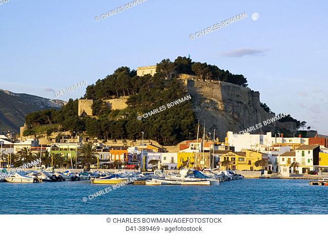 Spain, Alicante Province, Denia, marina, fort and waterfront with moon