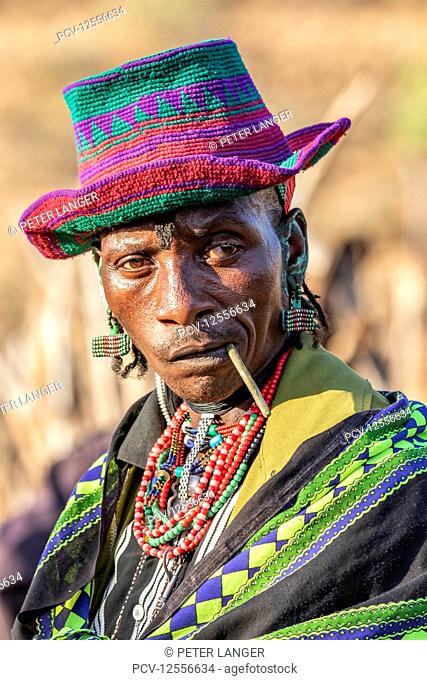 Hamer man wearing a colourful hat at a bull jumping ceremony, which initiates a boy into manhood, in the village of Asile, Omo Valley, Ethiopia