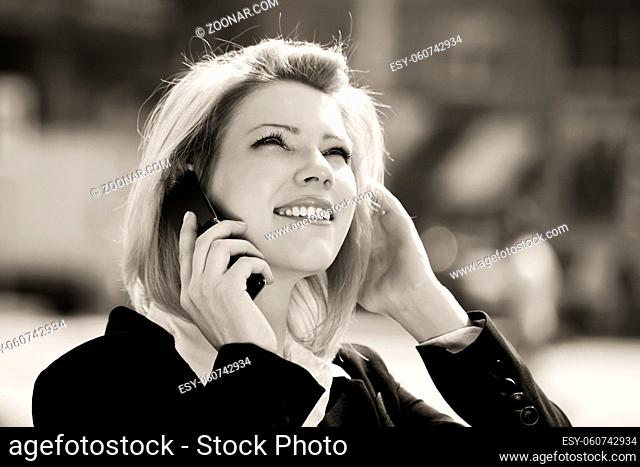 Fashion business woman calling on the cell phone outdoor