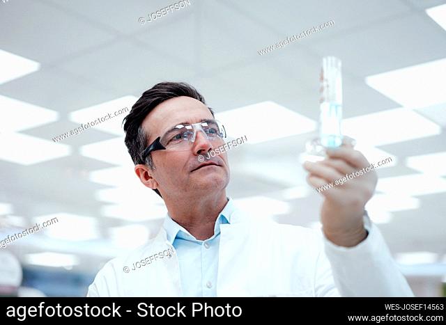 Chemist analyzing test tube in laboratory