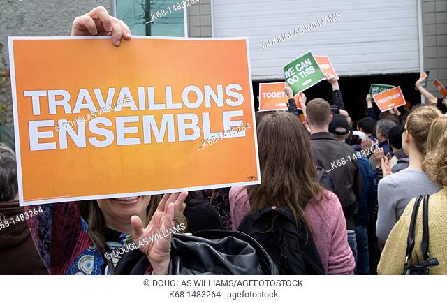 A woman holds a sign at a political rally for the New Democratic Party, NDP, before the federal election in Canada, 2011, in Burnaby, British Columbia, Canada