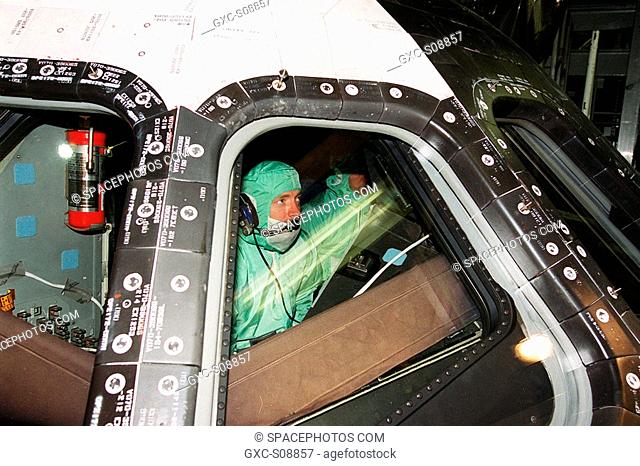 09/28/2001 -- During Crew Equipment Interface Test CEIT activities at KSC, STS-108 Pilot Mark E. Kelly checks the windshield inside orbiter Endeavour