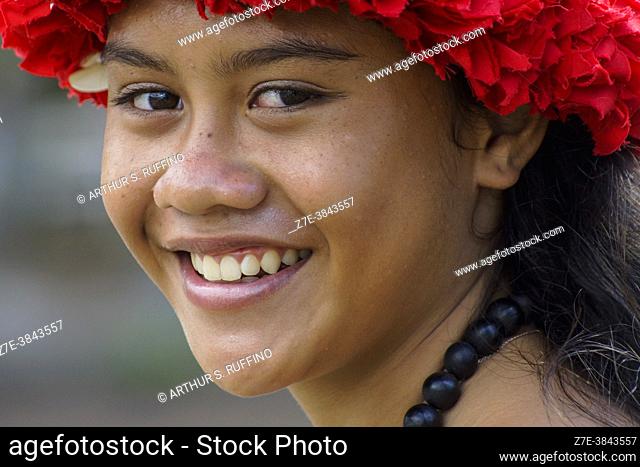 A young Marquesan woman greets arriving cruise passengers with a warm smile. Portrait. Taiohae Bay, Nuku Hiva, Marquesas Islands, French Polynesia