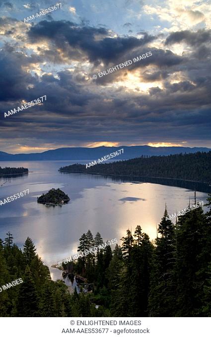 Storm clouds at sunrise over the still waters of Emerald Bay State Park, South Lake Tahoe region, California