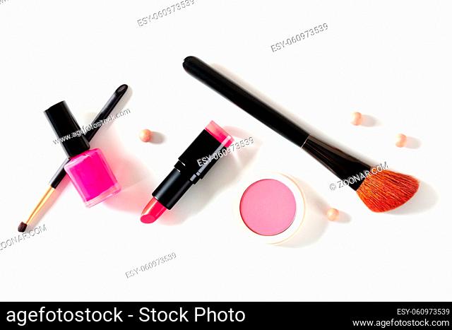Make-up tools on a white background, shot from the top. Brushes, lipstick and other accessories