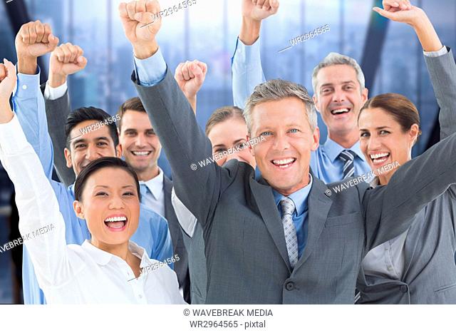 An happy Business group raising hands on the floor against building window background