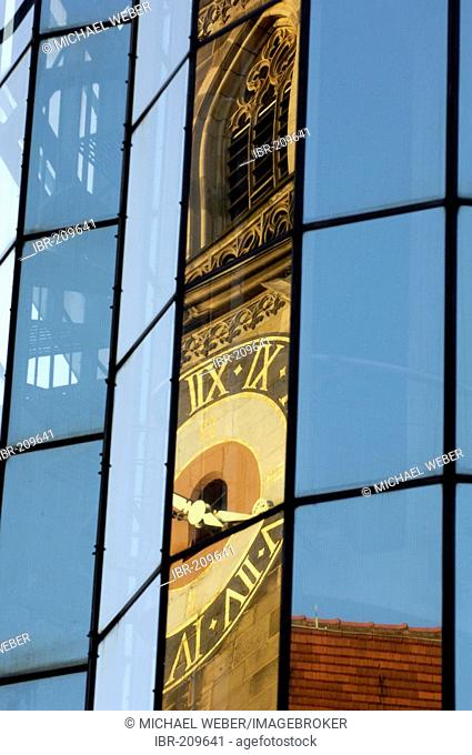 Stiftskirche (collegiate church) is reflected in glass cladding of a new building, Stuttgart, Baden-Wuerttemberg, Germany