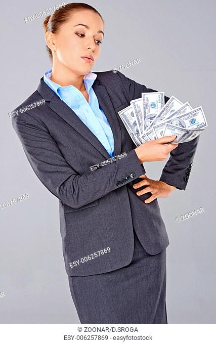 Successful businesswoman with a wad of money