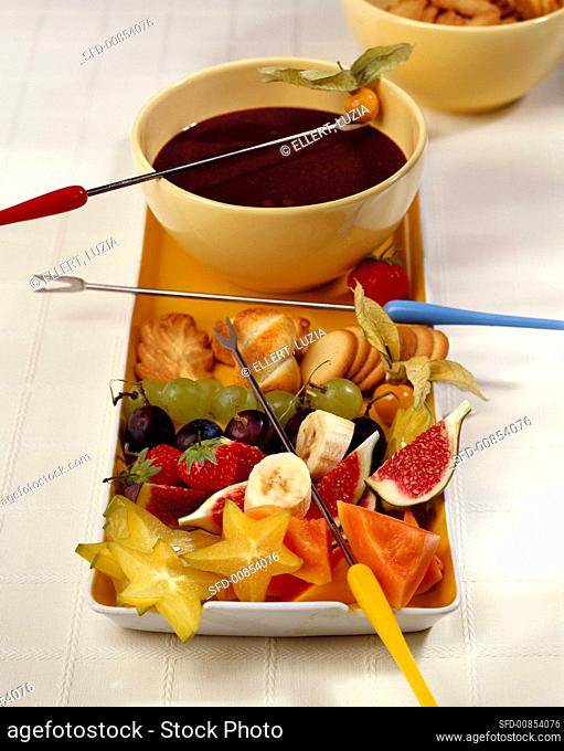 Chocolate fondue with fruit and biscuits
