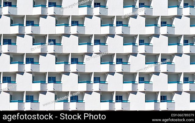 Full frame seamless background white residential house with blue glass balcony